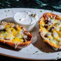 Irish Skins · Loaded with cheddar cheese, red onion, and crisp bacon served with sour cream. 