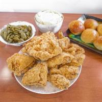 12 Pieces Fried Chicken Family Meal · Served with 2 large sides and 6 pieces of rolls or biscuits.