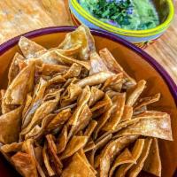 Chips con Guacamole · lightly fried corn tortillas cut in quarters  served with  freshly made guacamole, thinly sl...