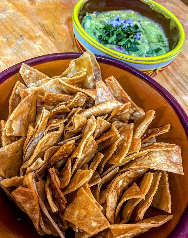Chips con Guacamole · lightly fried corn tortillas cut in quarters  served with  freshly made guacamole, thinly sliced onions and chopped cilantro.