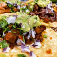 Taco de al Pastor · Spicy pork. Prepared with cilantro, chopped onions and guacamole. Served with red or green s...
