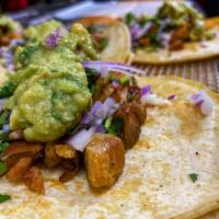 Taco de Pollo · Chicken. Prepared with cilantro, chopped onions and guacamole. Served with red or green sauc...
