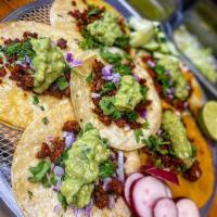Taco de Chorizo · Mexican sausage. Prepared with cilantro, chopped onions and guacamole. Served with red or gr...