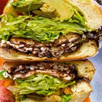 Torta de Bistec · Prepared with steak, refried beans, oaxaca cheese, lettuce, red tomato, mayo, chilies in vin...