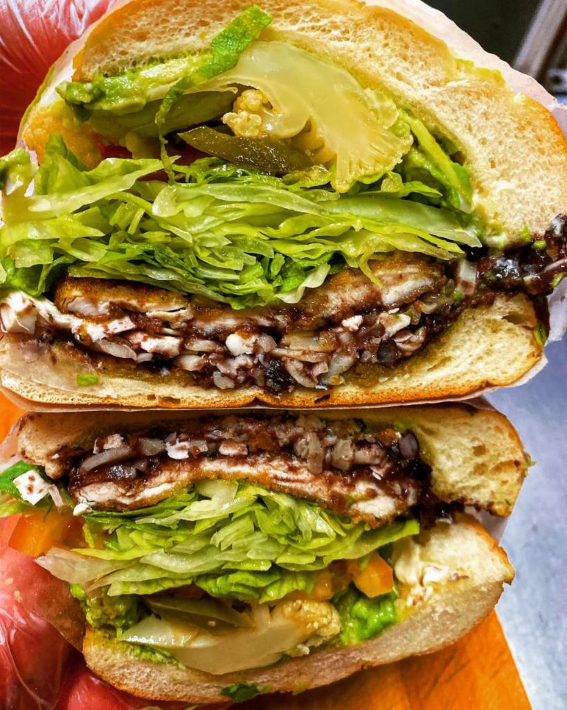 Torta de Chorizo con Huevo · Mexican sausage with egg. Prepared with refried beans, white cheese, lettuce, red tomato, mayo, chilies in vinegar and guacamole.