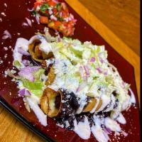 Papas con Chorizo Flauta · Potatoes with Mexican sausage. Prepared with refried beans, lettuce, red tomato, sour cream ...