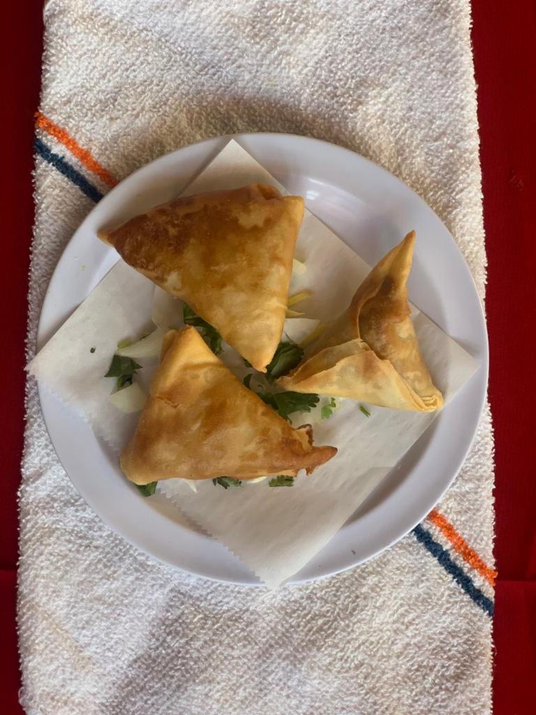 Lamb Samosa · Crispy triangular pastry turnovers filled with minced lamb seasoned with potatoes and green peas.