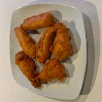 Chicken Pakora · Tender pieces of chicken dipped in mildly spiced lentil batter and fried.