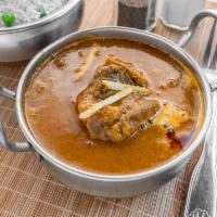 Goat Curry · Bone-in goat marinated and cooled in a curry sauce of fresh herbs and spices.