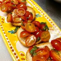 Bruschetta al Pomodoro · 4 slices. Classic cherry tomatoes and basil bruschetta. Vegetarian.