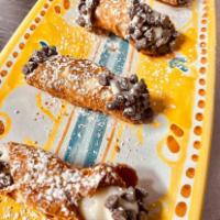 Cannoli · 4 Crunchy fried cannoli filled with ricotta cheese, chocolate drops.