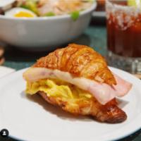 Ham and Cheese Croissant Sandwich · Country ham, soft scrambled egg and Gruyere cheese.