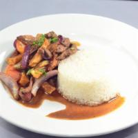 Lomo Saltado · Soft piece of steak or chicken, tomato, onions are seasoned with soy sauce and sauteed in a ...