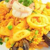 Arroz con Mariscos · Selected rice dancing in a hot pan along with fresh fruit of the sea, saffron and salsa crio...