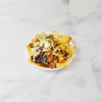 65. Nachos Supreme with Ground Beef Chili · Homemade white and yellow corn tortilla chips covered with melted cheddar cheese, tomato, gu...
