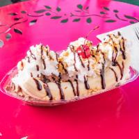 Banana Split · Banana sliced in half topped with 3 scoops of ice cream, chopped peanuts, whip cream, chocol...