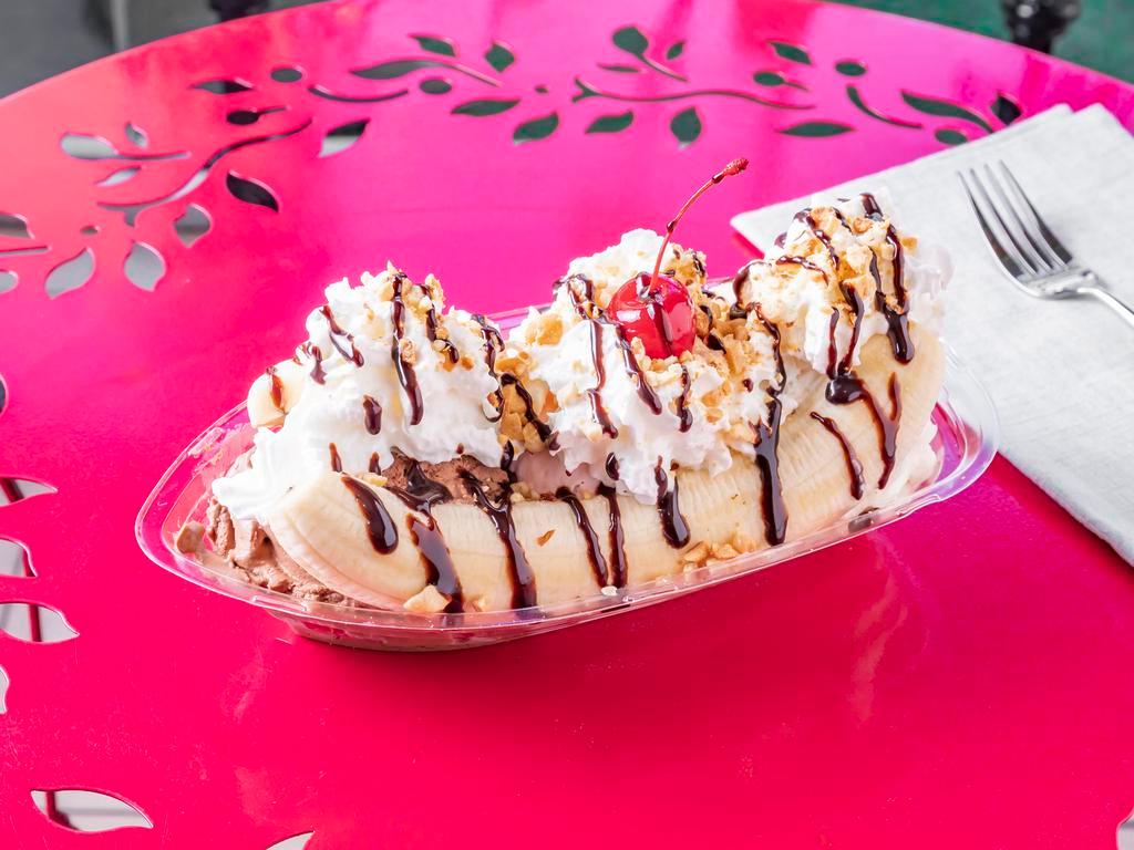 Banana Split · Banana sliced in half topped with 3 scoops of ice cream, chopped peanuts, whip cream, chocolate drizzle and a maraschino cherry.