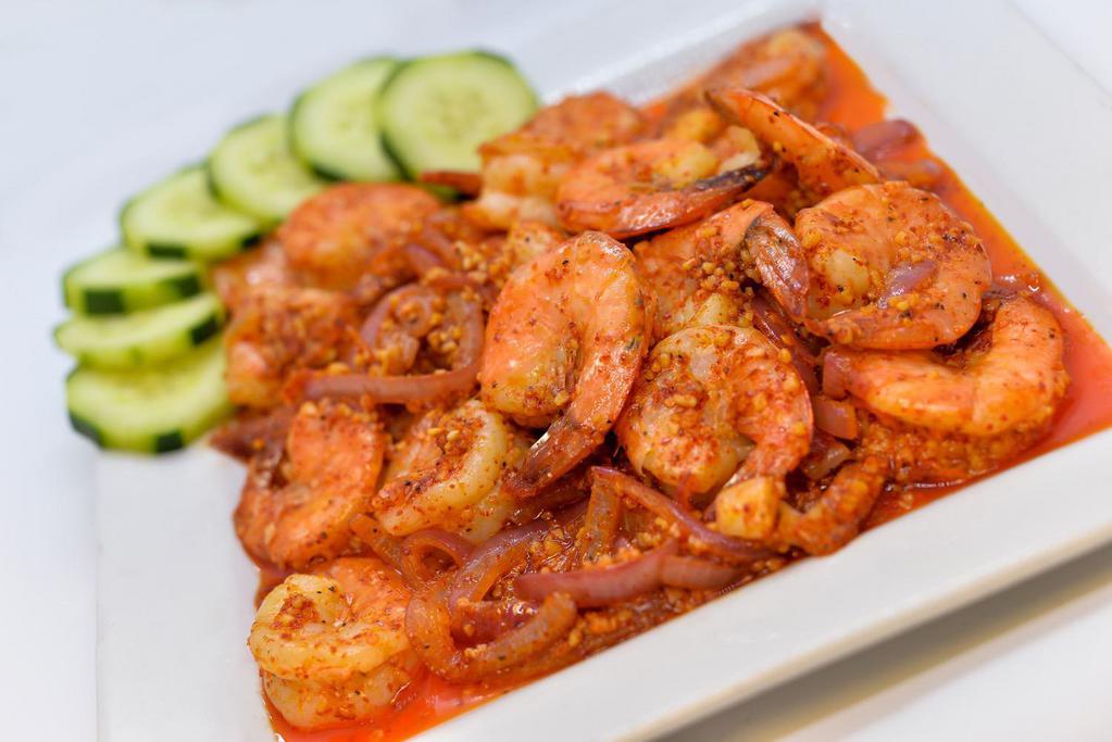 Camarones Pechas · 18 shrimp sauteed with cucumbers and onions. Served with rice.