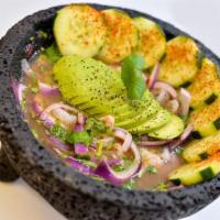 Aguachiles Pesquenos · Raw shrimp submerged in lime juice, peppers, cilantro, slices of onions, avocado, cucumber a...
