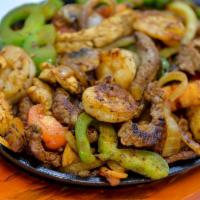 Fajitas Steak · Sizzling steak with green peppers, tomatoes, mushrooms and onions.