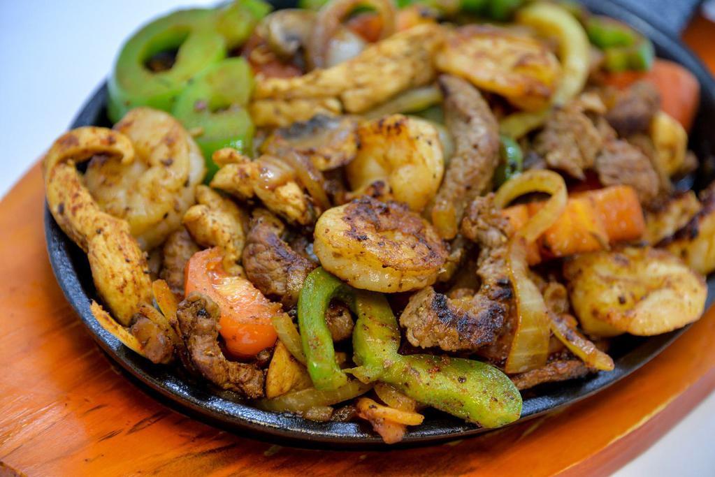 Fajitas Steak · Sizzling steak with green peppers, tomatoes, mushrooms and onions.