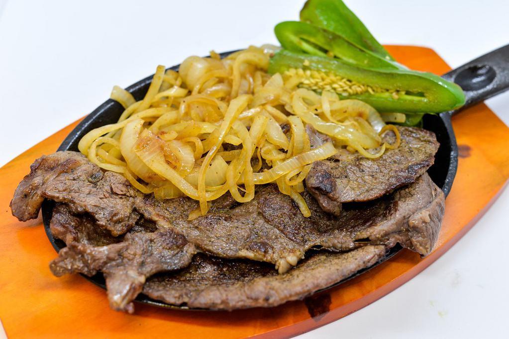 Carne Asada · Grilled sirloin steak, onions and jalapeno pepper. Served with rice, refried beans and tortillas.