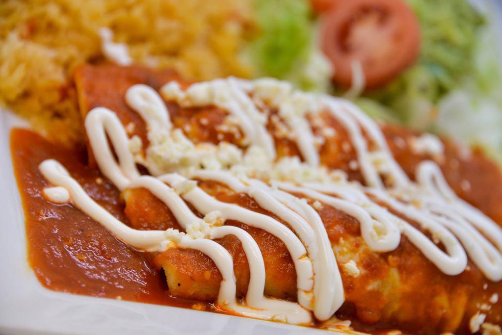 Entomatadas · 3 entomatadas filled with fresh cheese, topped with cheese, sour cream, fresh onions and served with rice and beans.