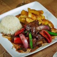 Lomo Saltado · Choice of protein sauteed with onions tomato served with potato and rice.