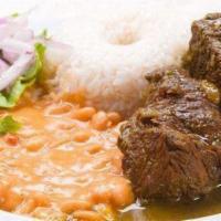 Seco Norteno · Beef slow cook in cilantro sauce served with rice pinto beans and onions sauce.