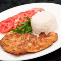 Milanesa · Breaded chicken breast served with rice pinto beans and salad.