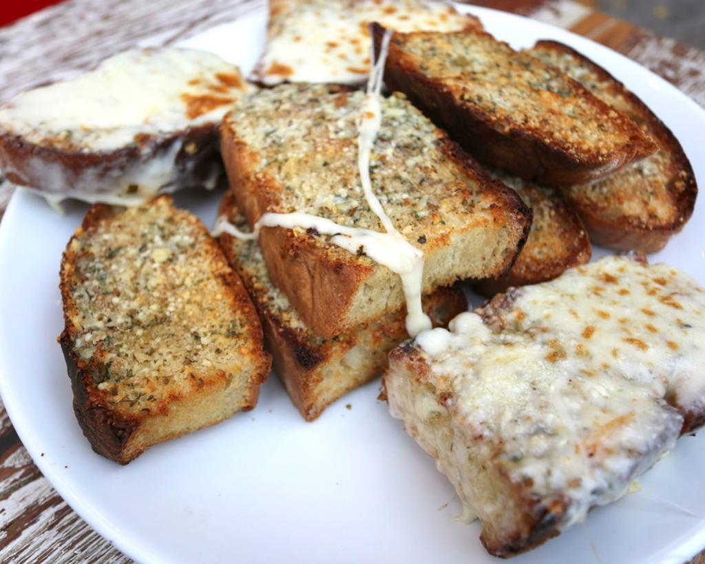Garlic Bread · Slices of Italian bread, thick cut with our homemade garlic butter. Add cheese for an additional charge. 