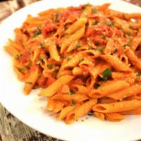 Penne alla Vodka · Made with Italian plum tomatoes, vodka, cream and Romano cheese with sliced onion, garlic an...