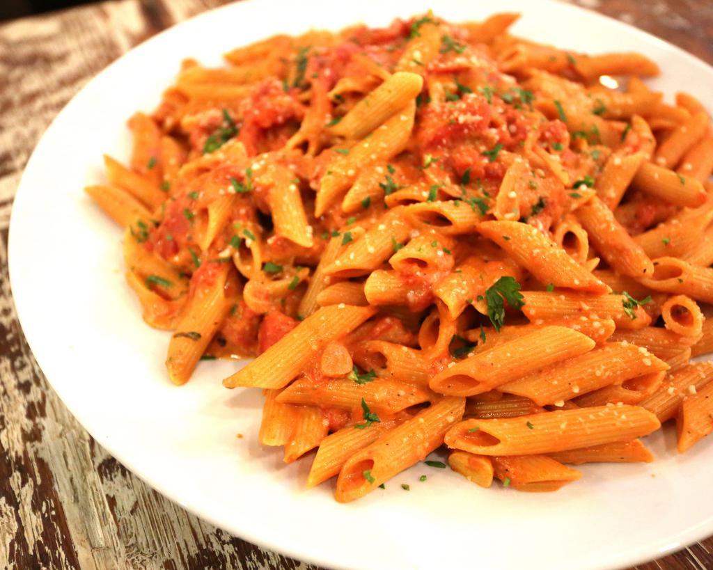 Penne alla Vodka · Made with Italian plum tomatoes, vodka, cream and Romano cheese with sliced onion, garlic and a pinch of crushed red pepper. 