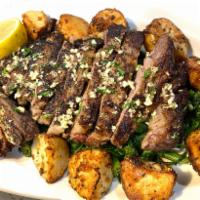 Rib Eye Steak · 22 oz. rib eye steak cooked to desired temperature topped with our homemade garlic herb oil,...