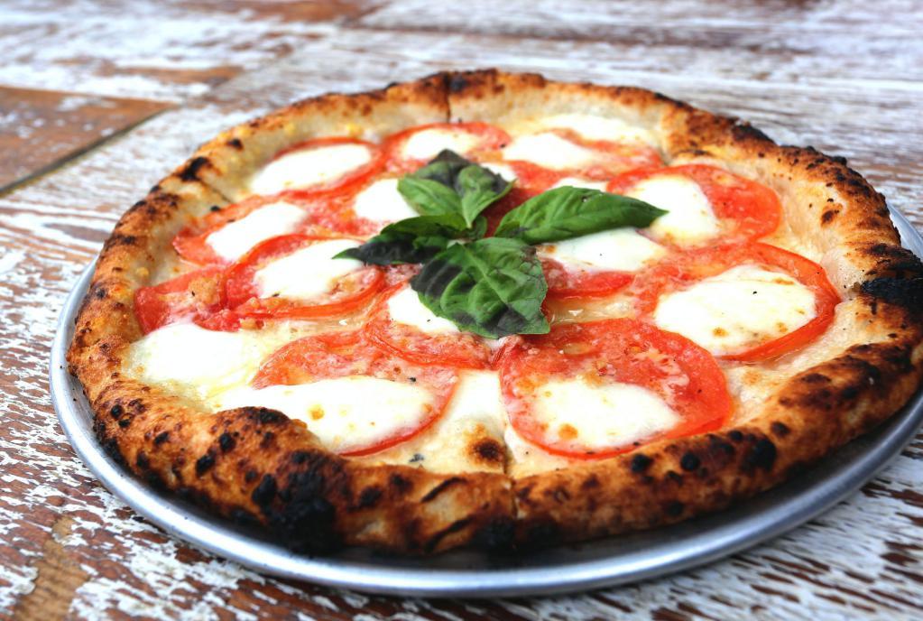Sophia Pizza · Fior di latte, marinated tomatoes, shaved Parmigiano and basil. Vegetarian. 