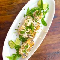 Elote (gluten free, vegetarian) · Grilled seasoned corn with Cotija and lime.