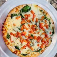 Mama’s White Pizza · Mozzarella, spinach, tomatoes, garlic, ricotta, and oregano.