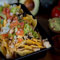 Nachos · Tortilla chips topped with choice of filling, beans, queso and salsa. Toppings include pico ...