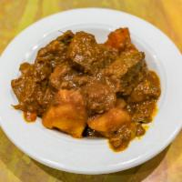 Beef Stew (Carne Guisada) · Choose one rice with a side of beans