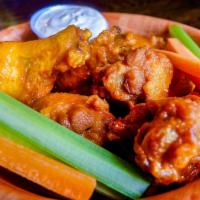 Waylon Wings · Crispy wings, topped with your choice of Buffalo or BBQ sauce served with our Cotija ranch d...