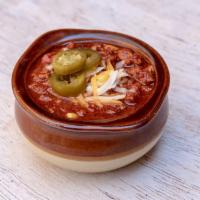 Bowl of Chili · House-made chili, topped with shredded queso, sour cream, and pickled jalapenos. Add chips o...