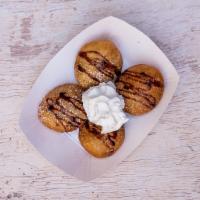Fried Oreos · Hand-dipped in pancake batter and fried, with chocolate sauce and powdered sugar. 