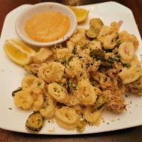 FRIED CALAMARI · crispy calamari & fried jalapenos, parmesan cheese, chipotle dipping sauce  