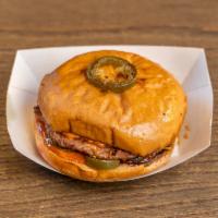Rodeo Burger · 1/4 lb. patty, cheddar cheese, grilled onions, jalapenos, and smokey BBQ aioli on a toasted ...