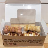 Doggy Donuts · Box of 2 donuts topped with peanut butter frosting, bacon, a dog biscuit, and peanut butter ...