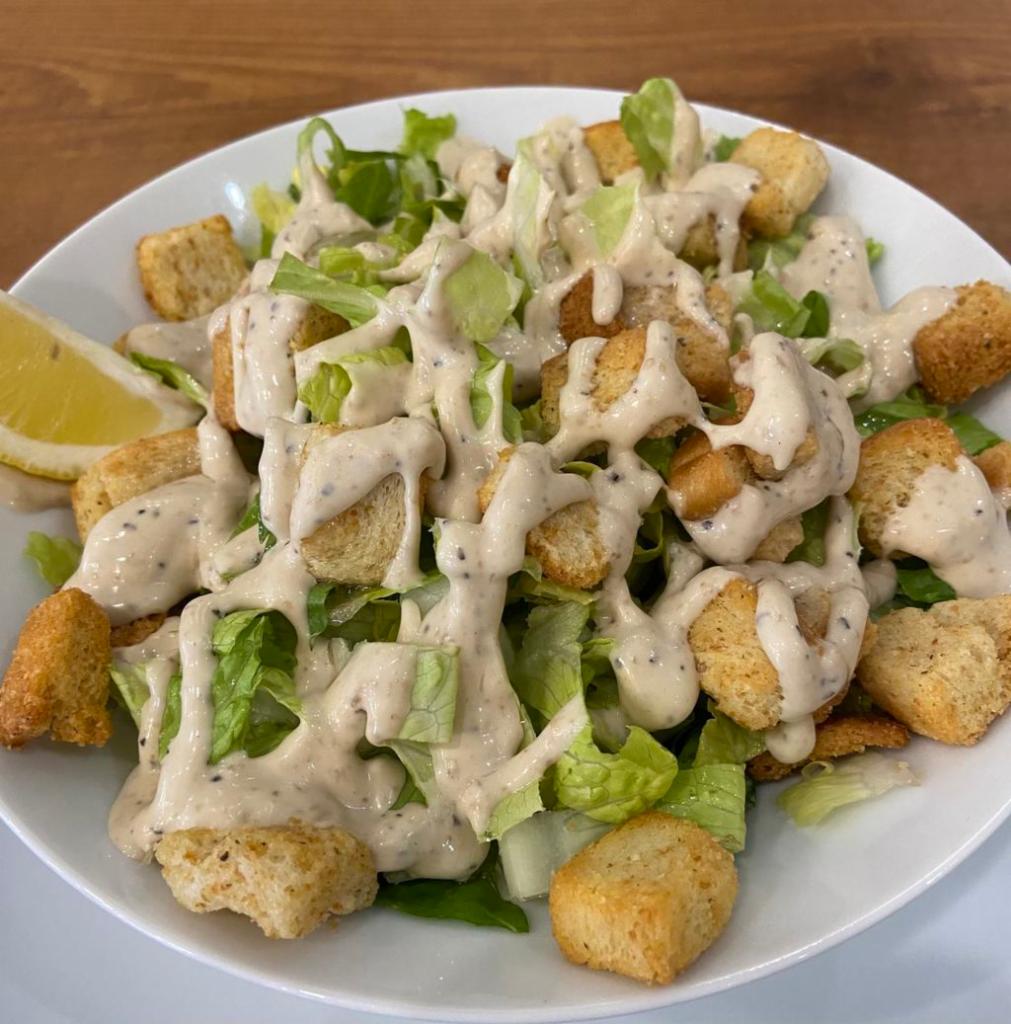 Caesar Salad · Romaine lettuce and croutons dressed with Parmesan cheese and Caesar dressing.