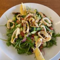 Calamari Salad · Arugula, kirby, tomato, onion, lemon juice, and olive oil topped with grilled calamari.