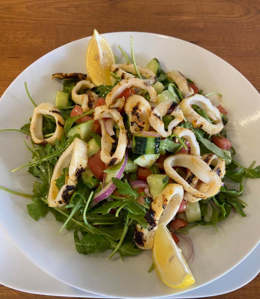Calamari Salad · Arugula, kirby, tomato, onion, lemon juice, and olive oil topped with grilled calamari.
