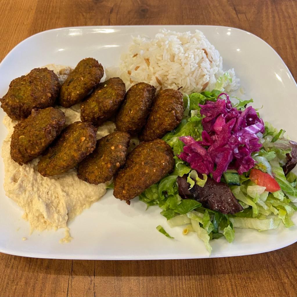 Dinner Falafel Plate · 9 pieces. Lighty vegetable balls made of chickpeas, celery, garlic, parsley, cilantro, tahini. Served with hummus, rice, and salad.
