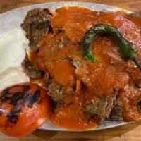 Iskender Kebab · Lamb gyro layer on homemade bread croutons, topped with garlic yogurt sauce. Served with spe...
